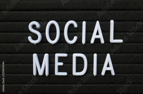 The words Social Media in white plastic letters on a black letter board 