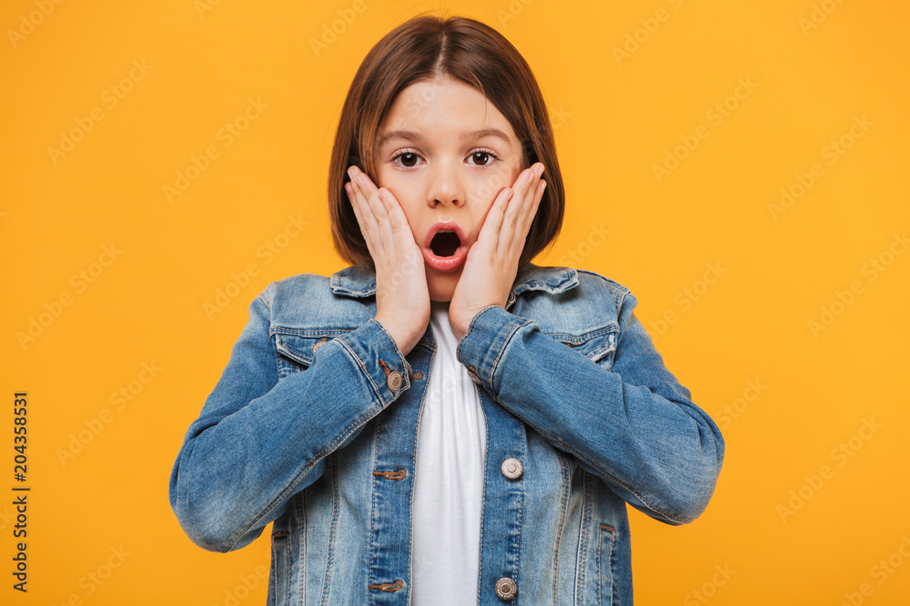Portrait of a surprised little schoolgirl looking at camera Portrait of a surprised little schoolgirl looking at camera