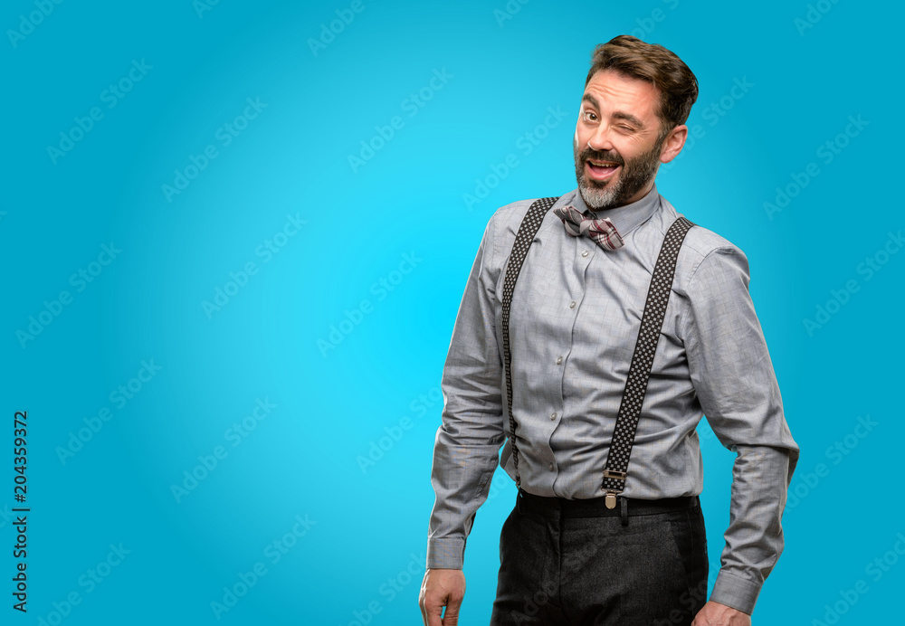 Middle age man, with beard and bow tie blinking eyes with happy gesture Middle age man, with beard and bow tie blinking eyes with happy gesture