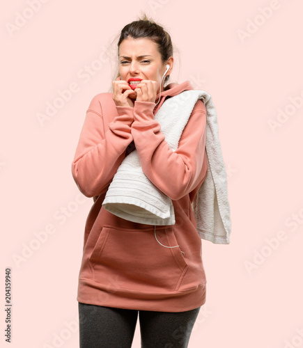 Young sport woman wearing workout sweatshirt terrified and nervous expressing anxiety and panic gesture, overwhelmed