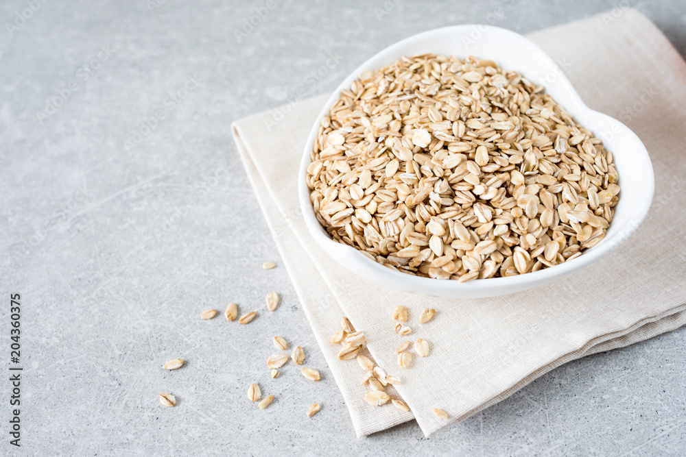 Food. Dry rolled oat flakes oatmeal on bowl. Healthy eating concept. Food. Dry rolled oat flakes oatmeal on bowl. Healthy eating concept.