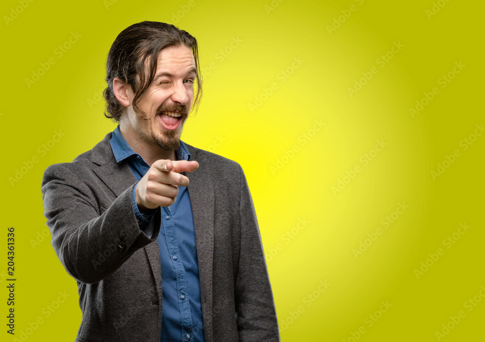 Handsome young man blinking eyes with happy gesture Handsome young man blinking eyes with happy gesture
