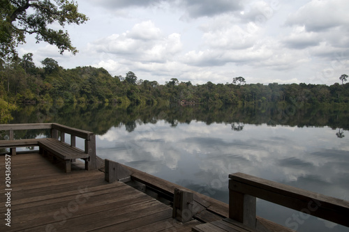 Banlung Cambodia  view of Yeak Lom lake from wooden pier with reflection of sky in water