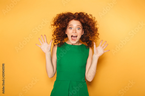 Portrait of an excited redhead woman in dress