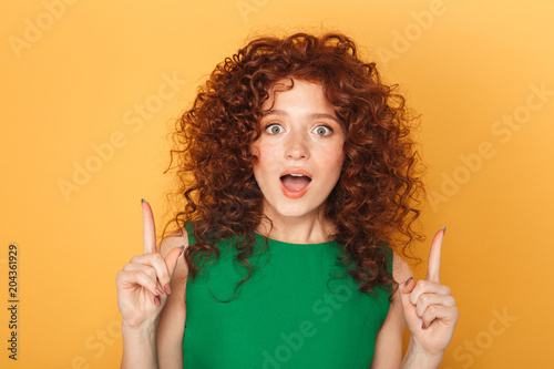 Close up portrait of a cheerful curly redhead woman