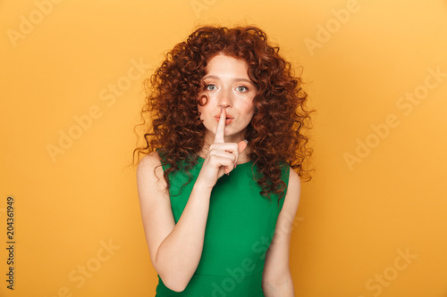 Portrait of a smiling curly redhead woman photo
