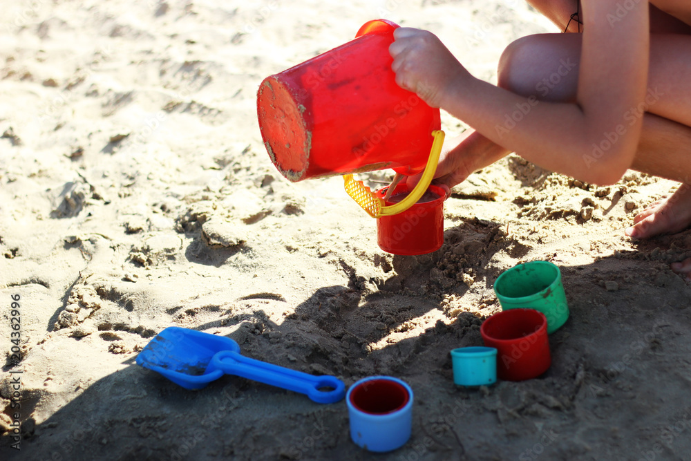 child playing with toys on the beach child playing with toys on the beach