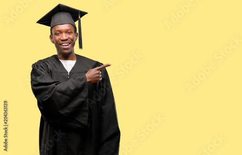 Konstfotografi Young african graduate student black man pointing away side with finger
