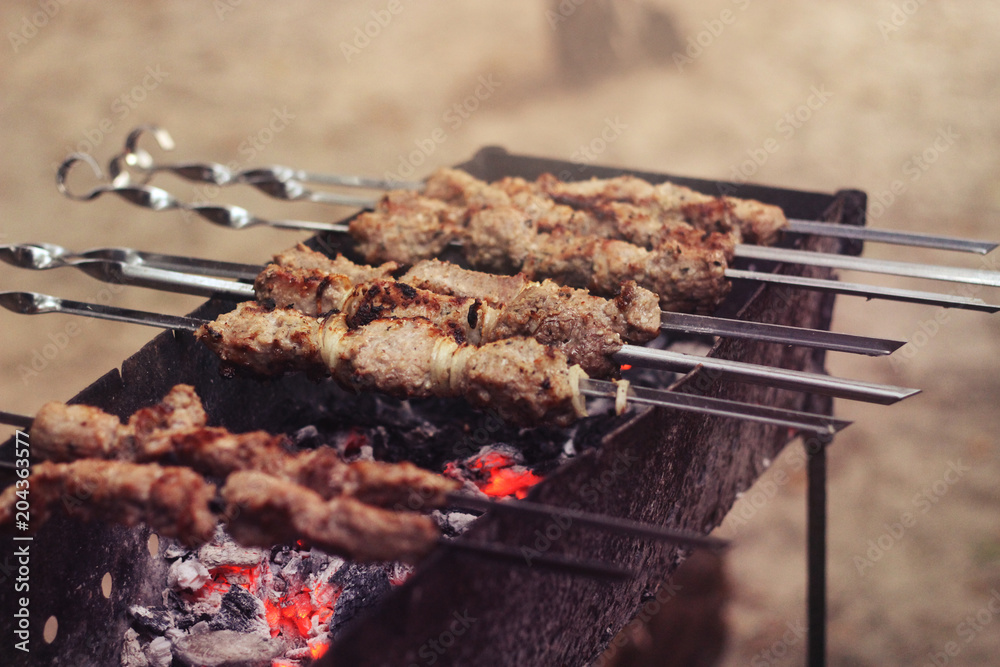 Cooked pork meat. Barbecue lunch. Appetizing shashlik closeup