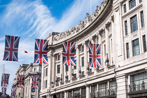 Close up of buildings on Regent Street London UK photographed from street level, with row of British flags to celebrate the Royal Wedding of Prince Harry to Meghan Markle. photo