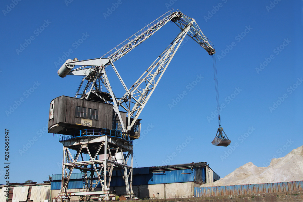 vintage crane at the docks of a harbor