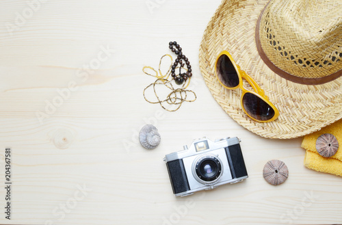 Flat lay image of accessory clothing women to plan travel in holiday  wooden background concept.