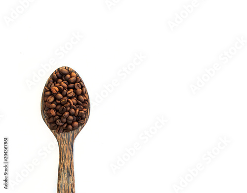 Coffee Beans in wooden spoon on white.