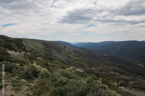 Mountains in Kosciuszko National Park with grass shrubs and dark clouds