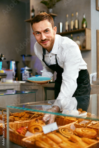 Man Selling Bakery In Pastry Shop