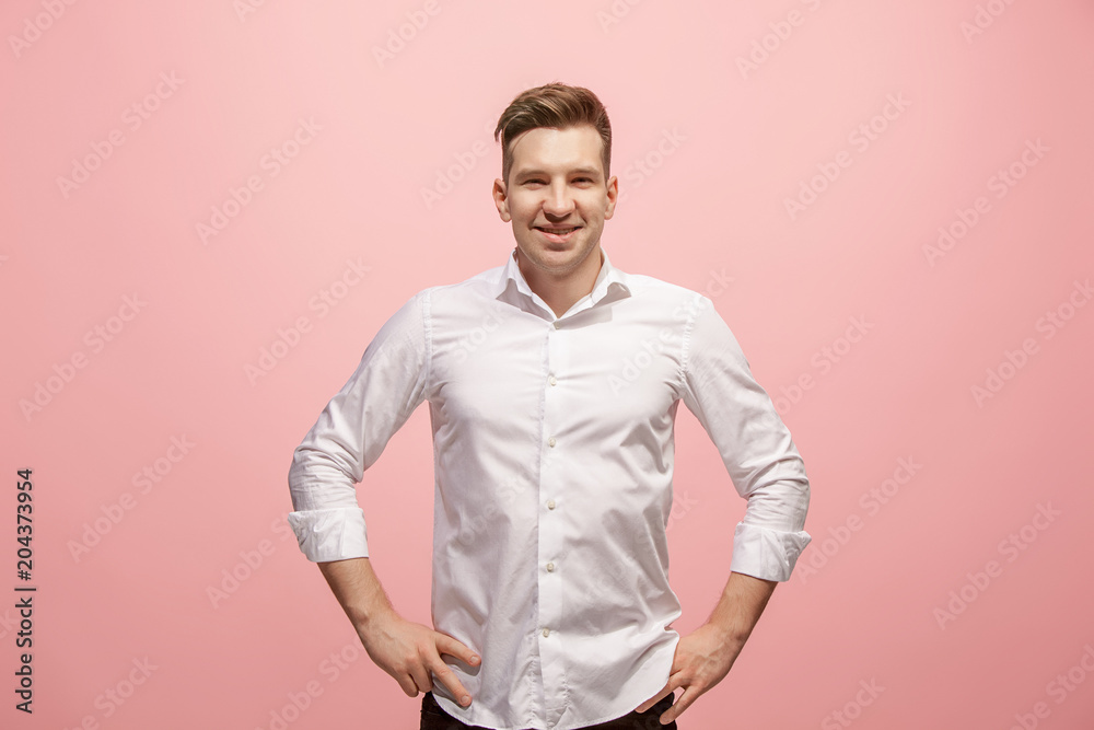 The happy business man standing and smiling against pink background. The happy business man standing and smiling against pink background.