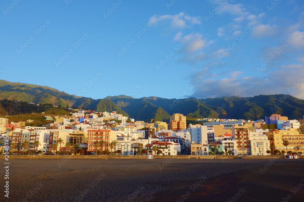 Colorful sunrise on the beach overlooking the capital city Santa Cruz de la Palma together with the mountains, Canary Islands, Spain