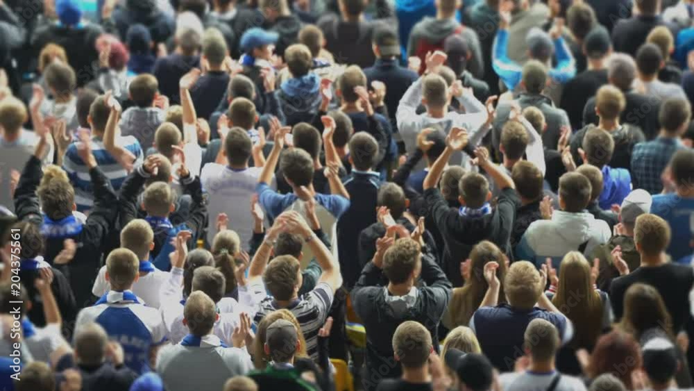 Sports fans clapping hands at stadium, supporting their team, excited crowd. Fans watching game, 4K