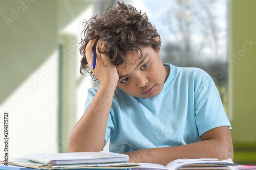 Canvas Print Young school boy having trouble with his homework