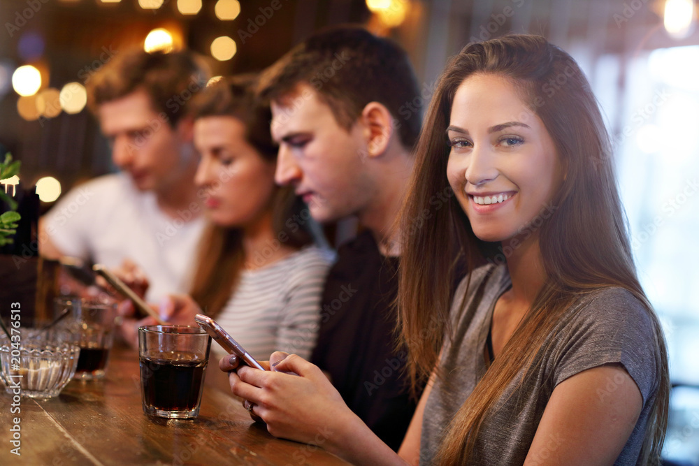 Group Of Friends Enjoying Meal In Restaurant