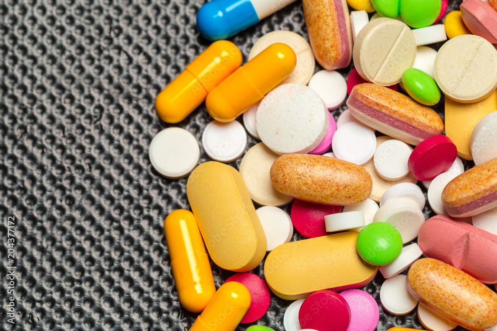 tablets and pills on dark background tablets and pills on dark background