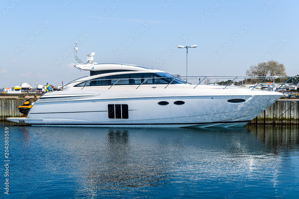Luxurious motorboat tied to a pier. Logos and id removed. Luxurious motorboat tied to a pier. Logos and id removed.