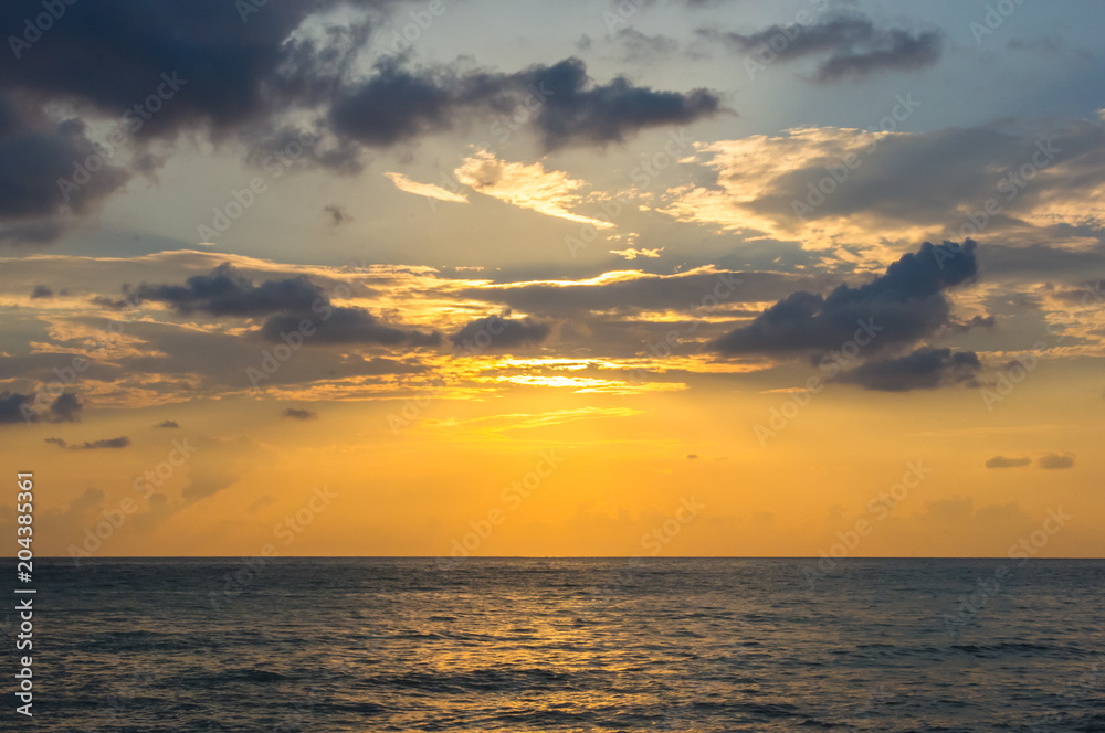 Fototapeta premium Amazing sea sunset, the sun, waves, clouds