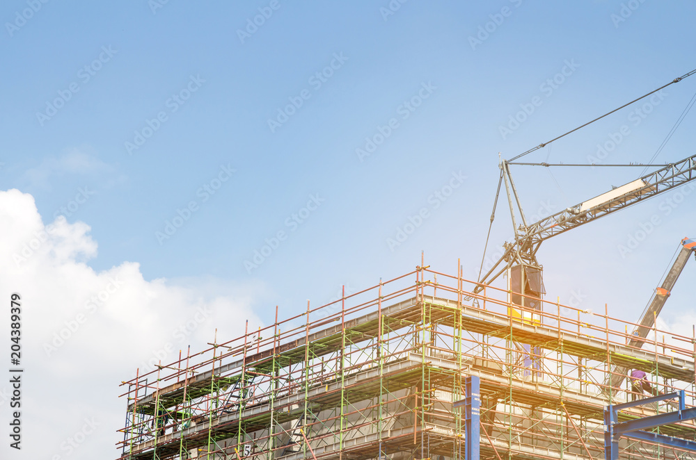Lots of tower Construction site with cranes and building with blue sky background,scaffolding for construction factory