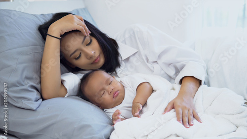 Young mother and little boy lying on the bed