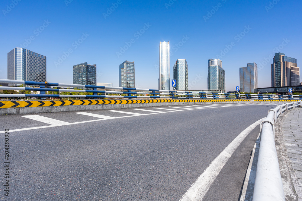 asphalt road with panoramic cityskyline