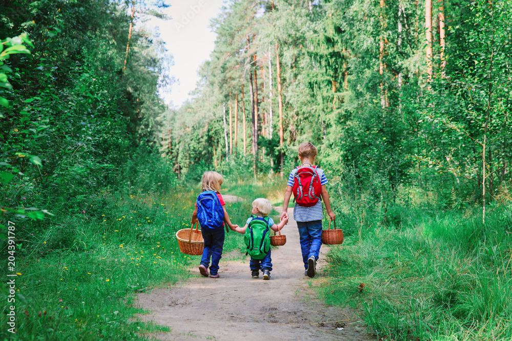Fototapeta premium little boy and girls going to forest