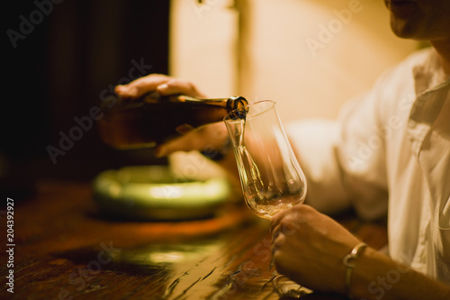 Beer being poured into a glass by a man.