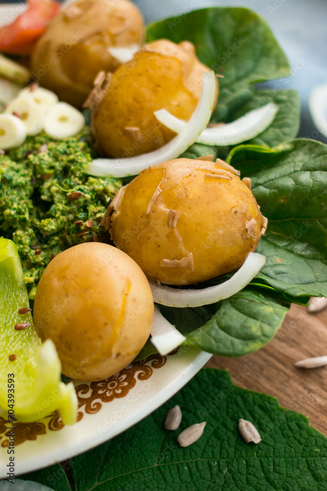 Cooked or backed new potato with fresh vegetables on lunch or dinner. Farm organic products. Raw vegan vegetarian healthy food Cooked or backed new potato with fresh vegetables on lunch or dinner. Farm organic products. Raw vegan vegetarian healthy food