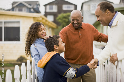 Father, son and daughter visiting Grandfather