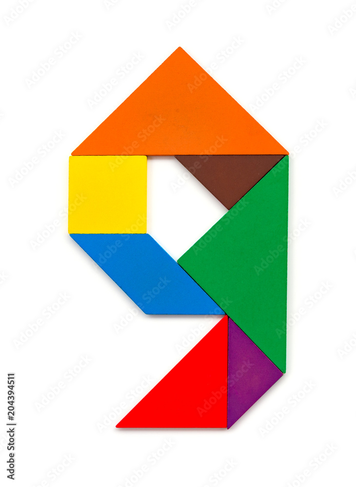wooden tangram shaped like a number 9 on white wooden tangram shaped like a number 9 on white