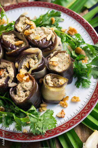 Roasted eggplant rolls with walnuts, garlic, coriander, oil, onion. Traditional Georgian food cold snack. Rolls for dinner or lunch. Raw vegan vegetarian healthy food