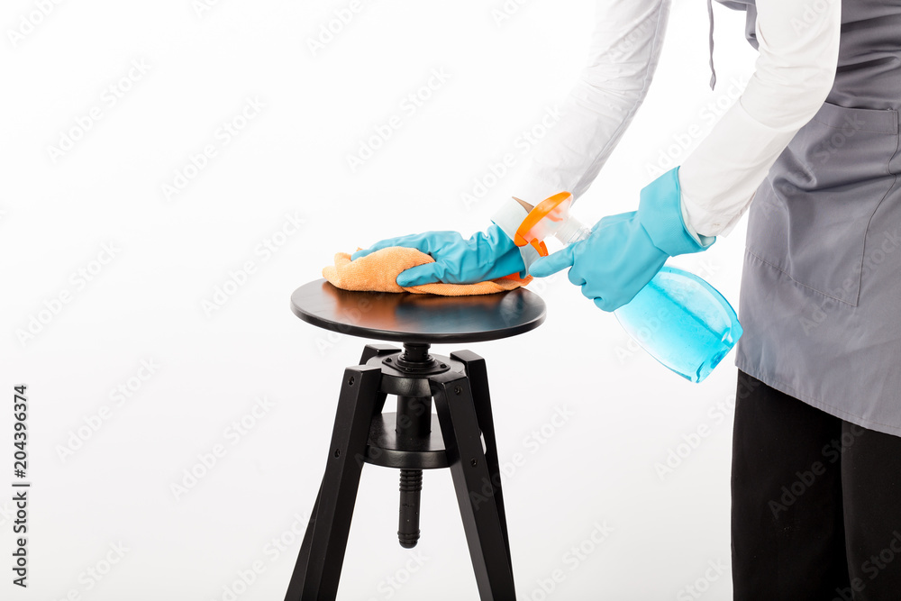 Maid cleaning chair with spray and microfiber,Isolated on white background,Cleaning concept Maid cleaning chair with spray and microfiber,Isolated on white background,Cleaning concept
