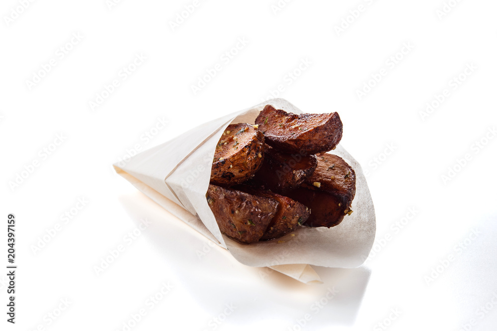 French fries in a gift wrapping on a white background (close) French fries in a gift wrapping on a white background (close)