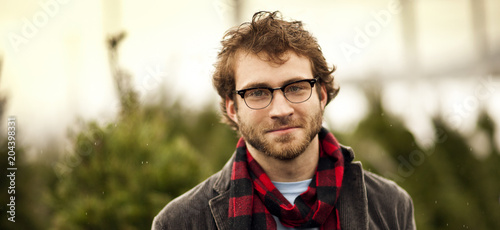 Portrait of young man at a Christmas Tree farm. photo