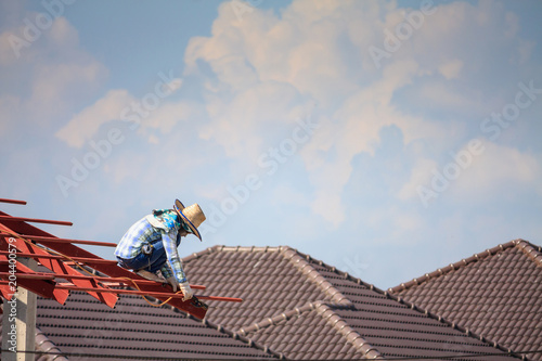 welder workers installing steel frame structure of the house roof at building construction site © Piman Khrutmuang