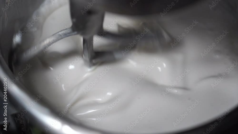 4K Slow Motion Movie of Flour, White Eggs and Water in dough mixing machine, bakery ingredient mixed in the machine 4K Slow Motion Movie of Flour, White Eggs and Water in dough mixing machine, bakery ingredient mixed in the machine