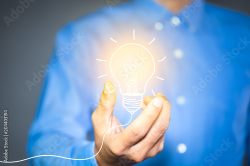 Light bulb drawn in the hands of businessman. new ideas, Innovative idea concept.