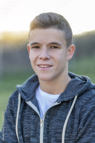 portrait of a attractive teenager standing and looking to you casual eyeglasses