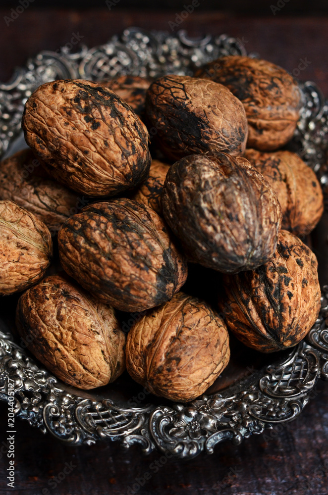 Whole walnuts on a rustic plate