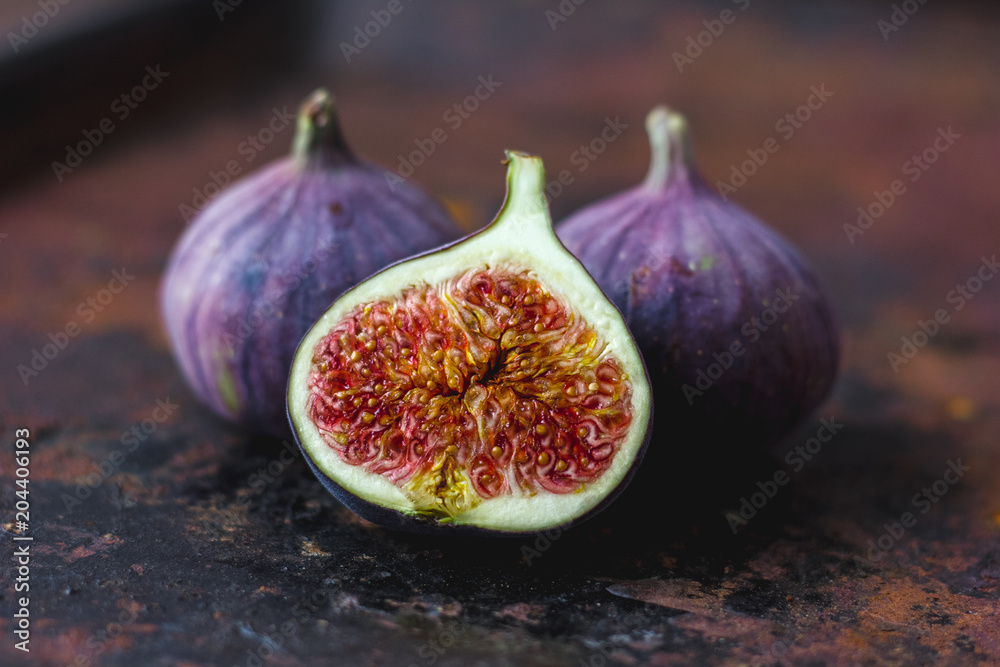 Beautiful and fresh figs on rusty surface. Half of fig.
