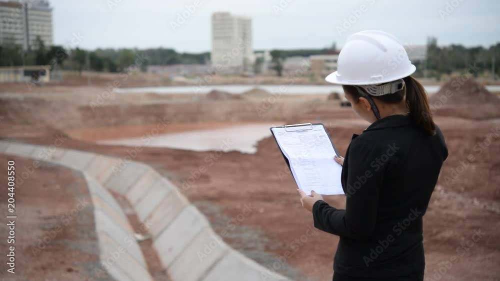 Engineer woman working at site of building under construction Engineer woman working at site of building under construction