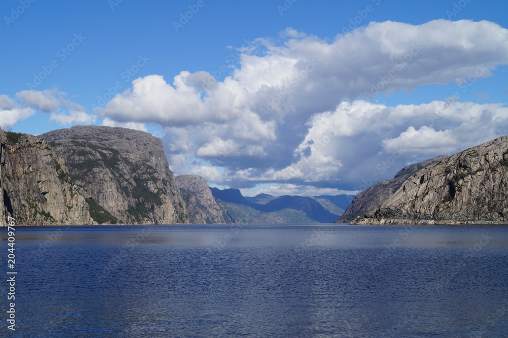 Norwegian fjords with blue sky and clouds