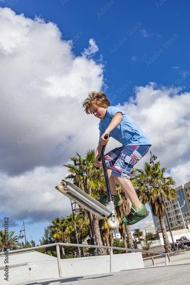boy with scooter is going airborne boy with scooter is going airborne