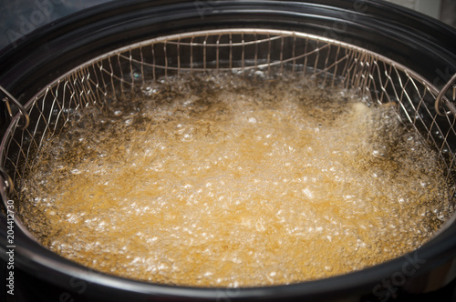 closeup of french fries in a deep fryer