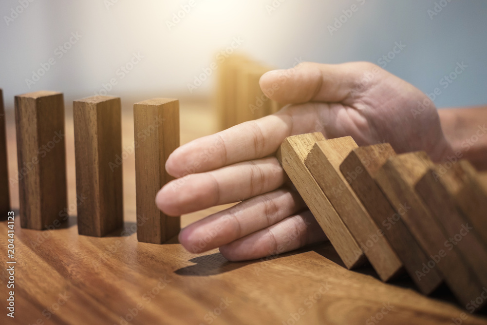 Φωτογραφία Risk and strategy in business, Close up of businessman hand stopping wooden bloc